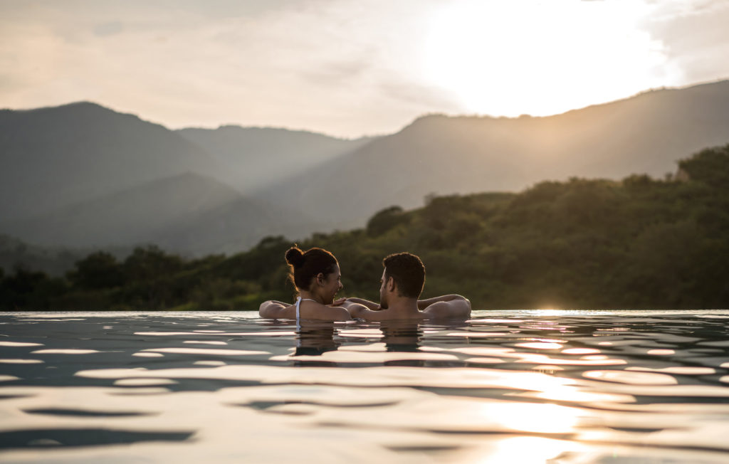 Discover romantic sights like this mountain view from the pool when you take a tailor-made honeymoon with Alfred&.