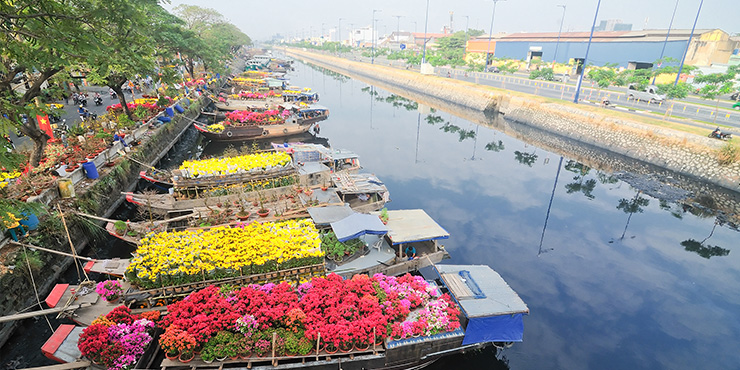 Flower boats along canal on New Year festival, Vietnam