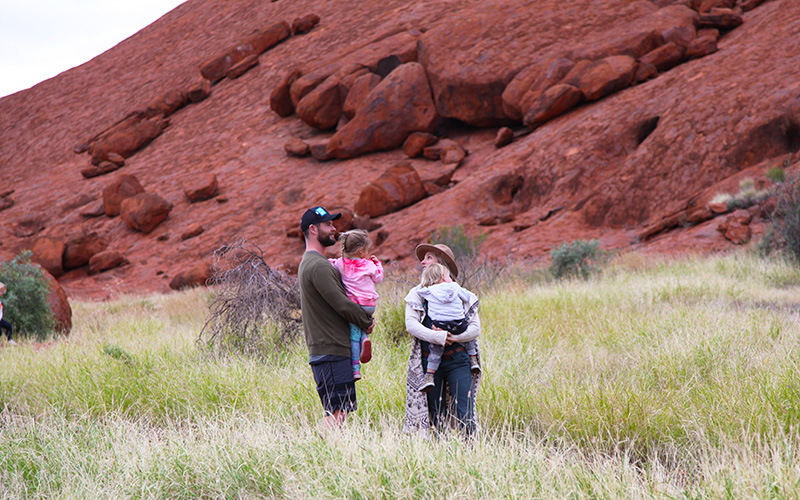 Chris looks on at impressive Uluru with his family