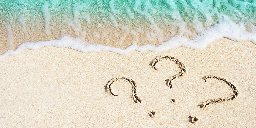 Question marks on a beach
